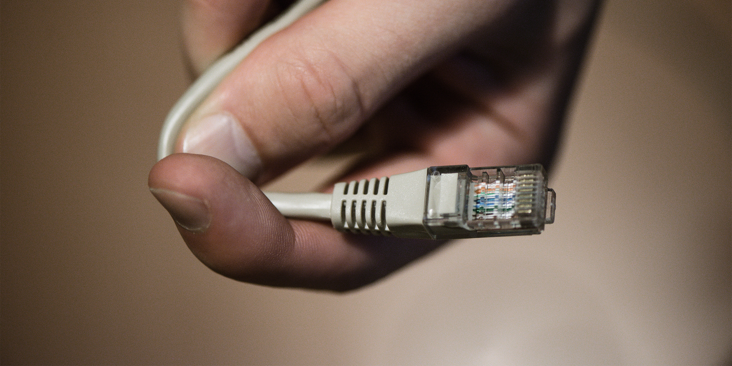 hand holding ethernet cable coronavirus broadband