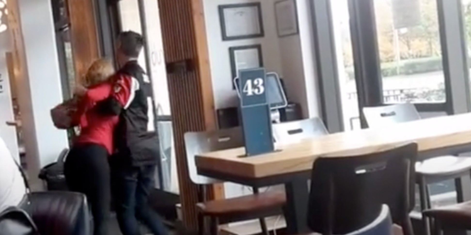 The woman being carried out by her companion