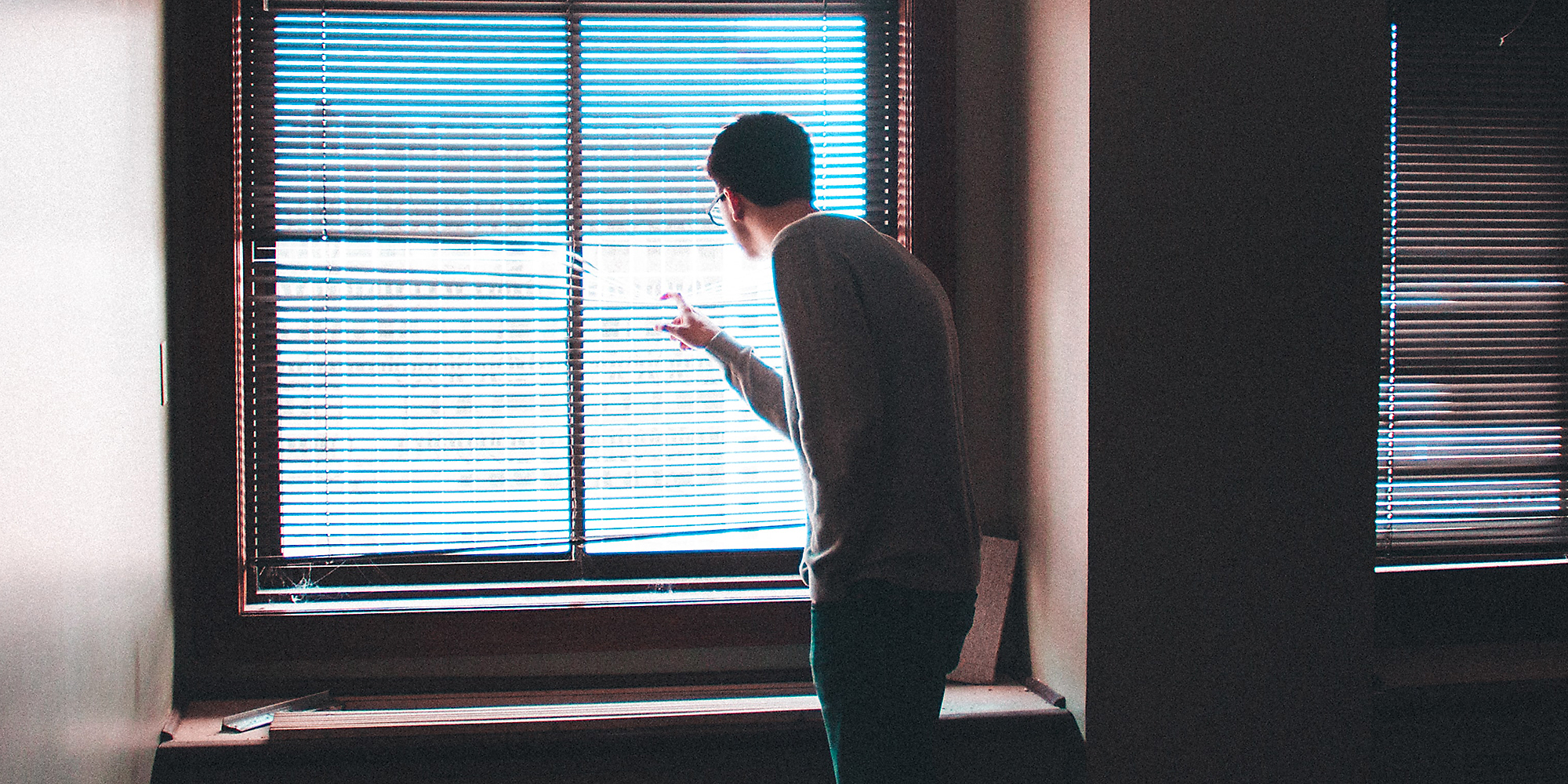 A man looking out a window.