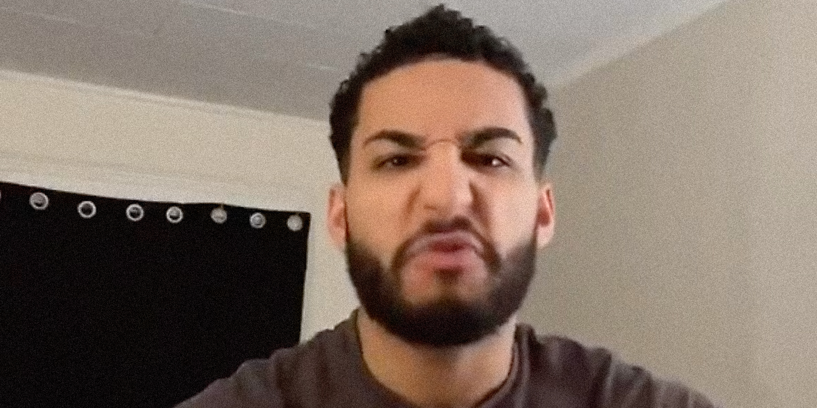 A man yelling into camera.