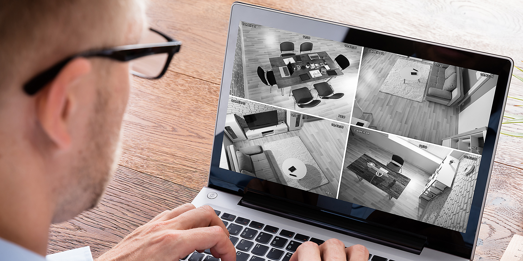 A man looking at security camera footage.