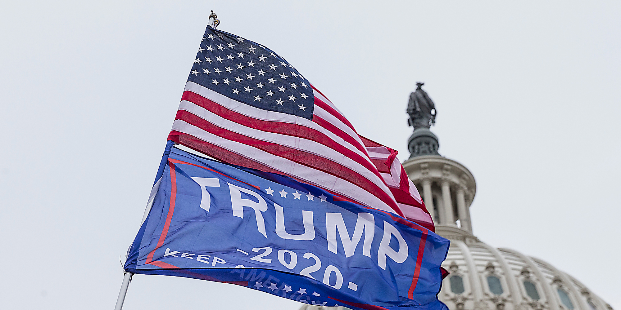 A United States flag and Trump 2020 flag.