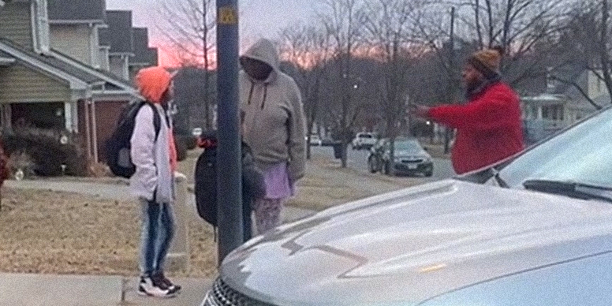 man pointing at adult and children