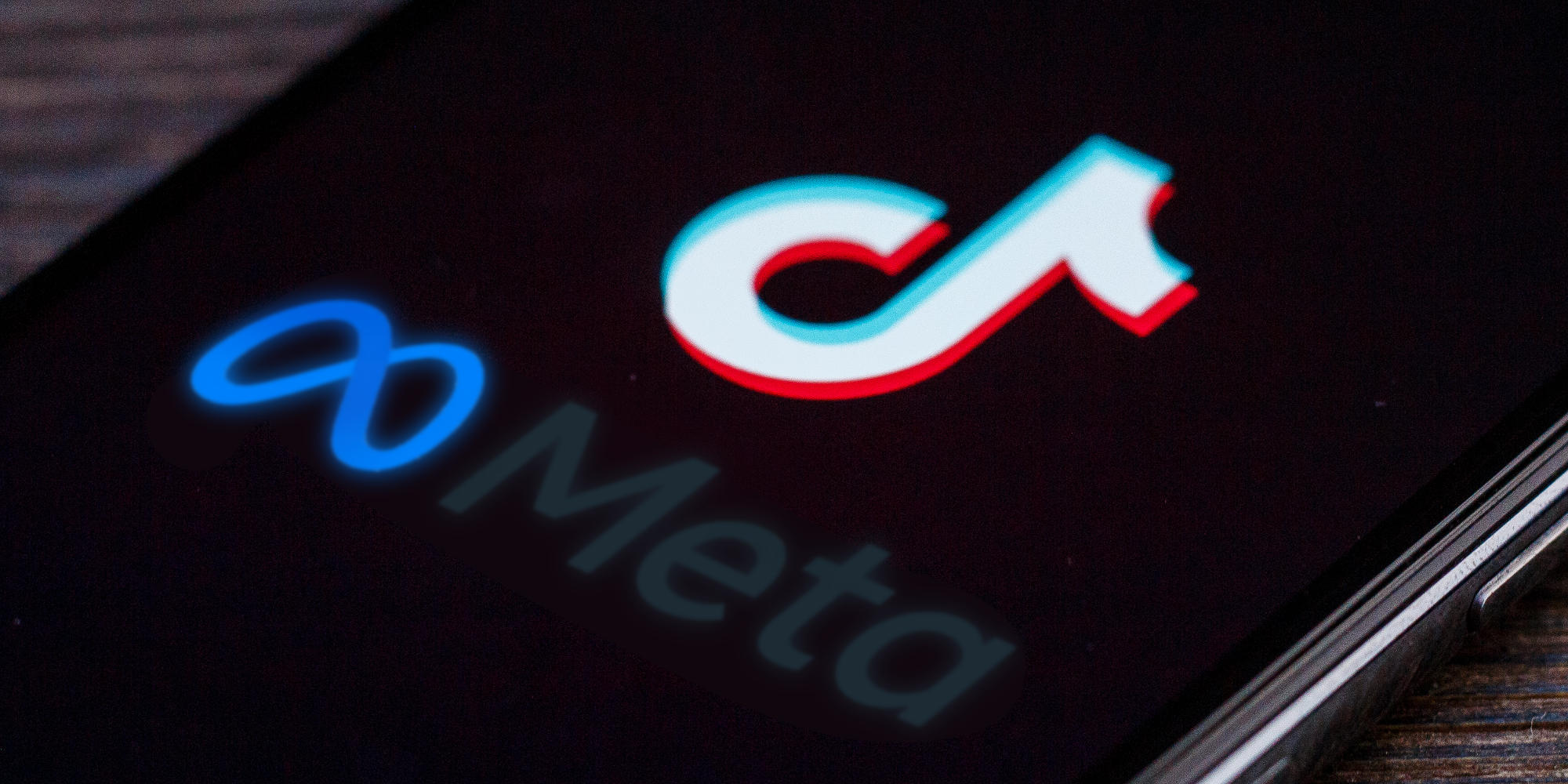 phone with tiktok logo and meta logo