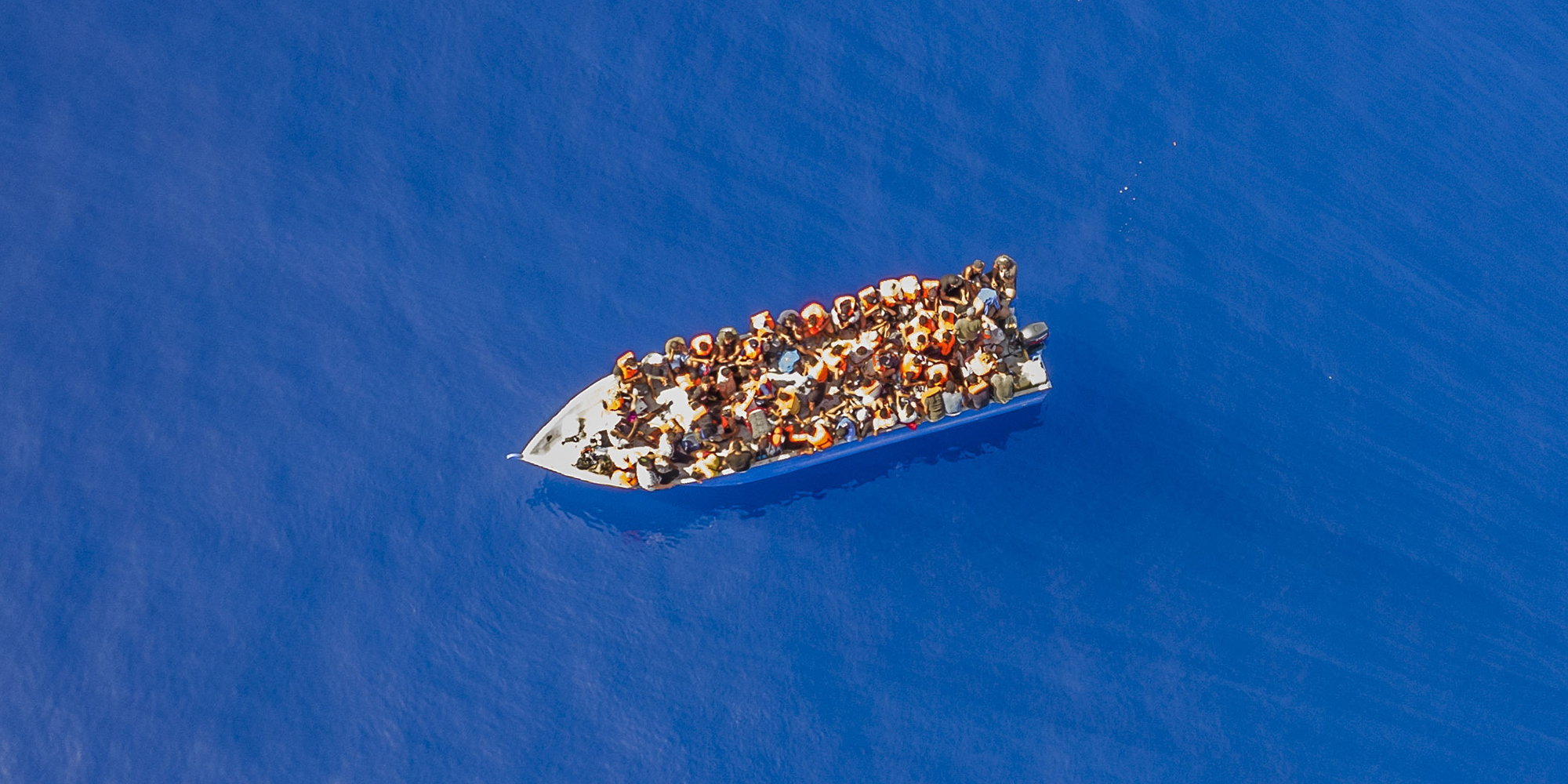 A small wooden boat filled with people