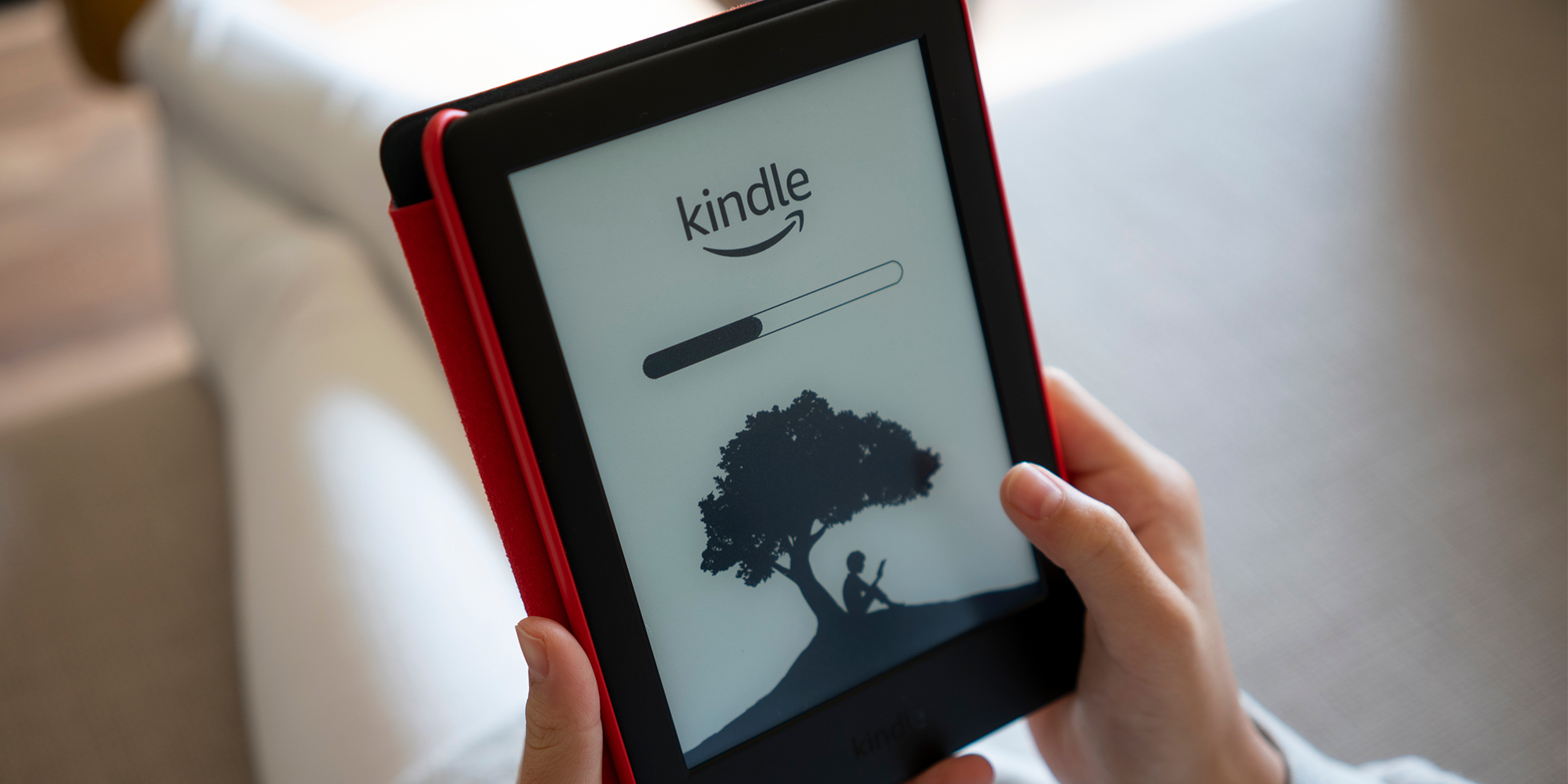 hands holding kindle