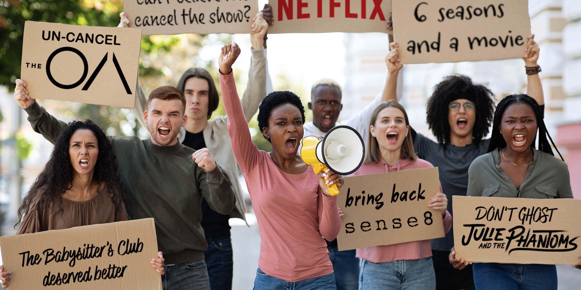 Demonstrators striking on the street, holding megaphone and placards.