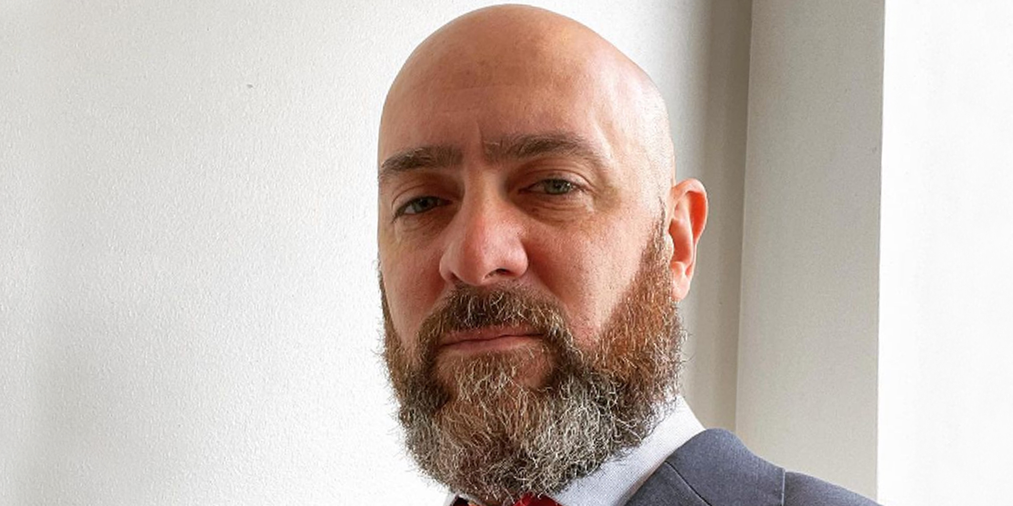 Jonathan David Rinaldi GOP candidate in front of light walls