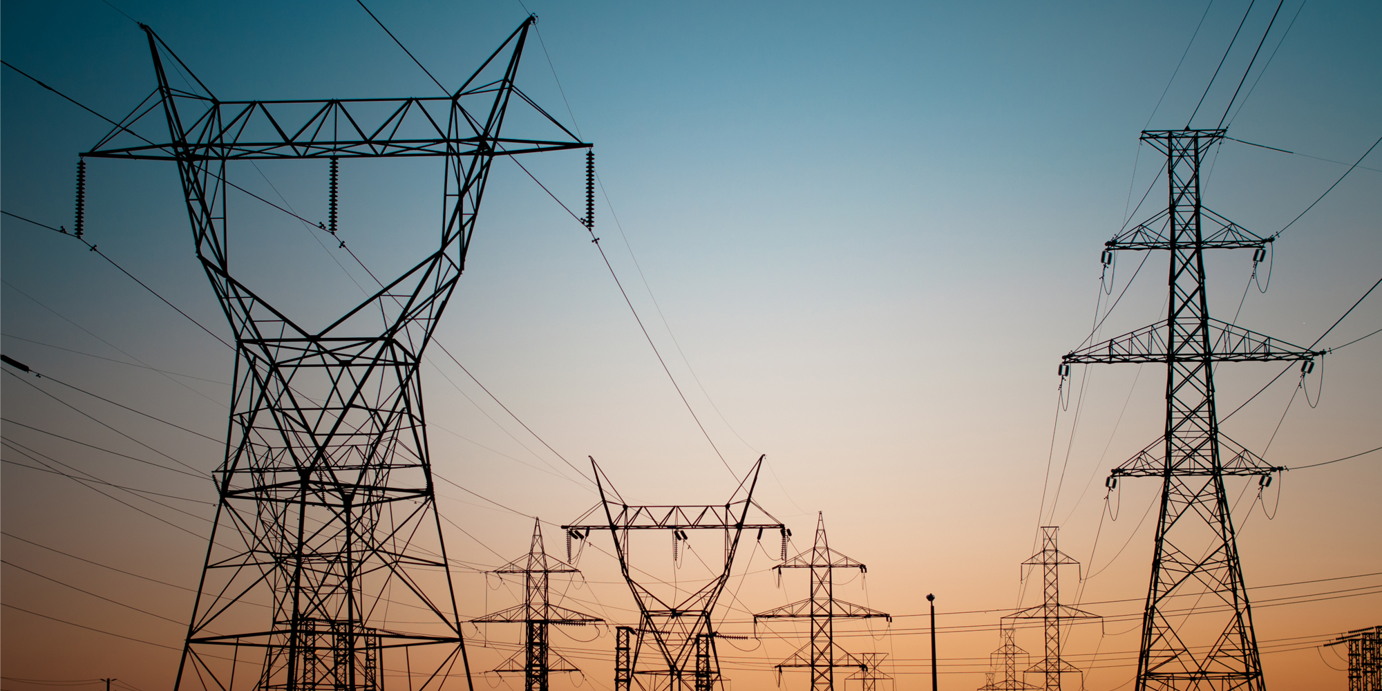 electrical transmission towers with sunset