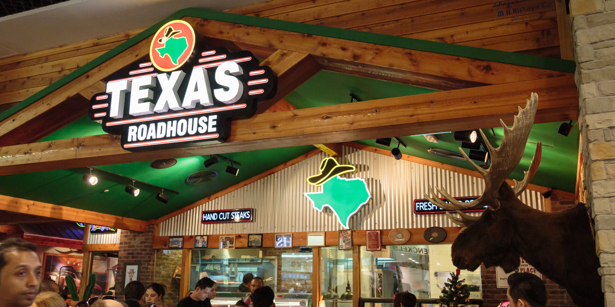Texas Roadhouse family meals - Texas Roadhouse interior with customers and sign