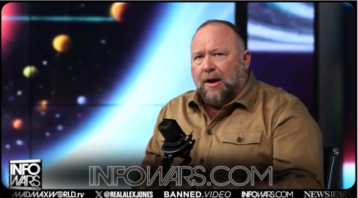 alex jones in front of his Infowars set