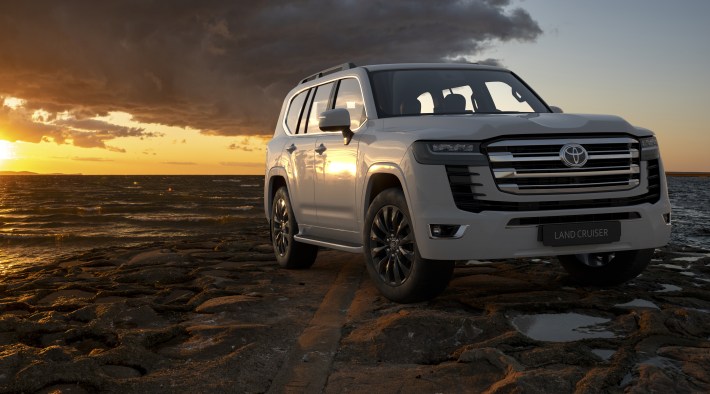 White Toyota Land Cruiser in wet rocky terrain