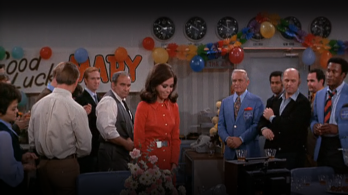 fake news outlets - Mary Richards celebrating in the newsroom with her co-workers, including Ted Baxter and Lou Grant, in an episode of "The Mary Tyler Moore Show."