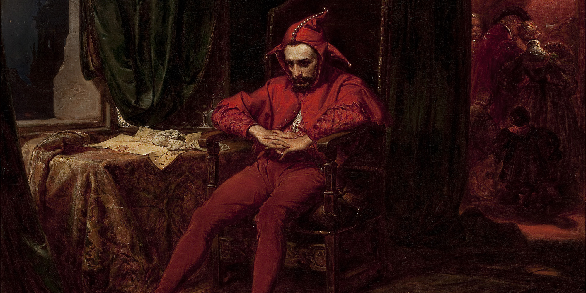 red jester sitting in chair