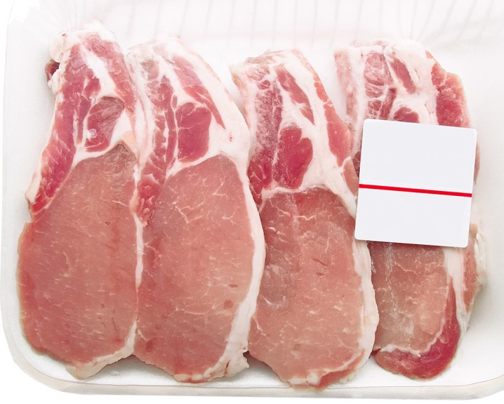 Pork chops packaged in a container with a price tag