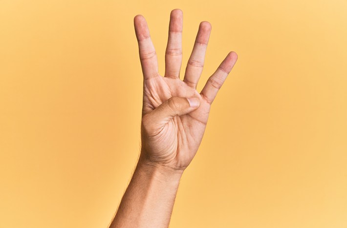 Arm and hand of caucasian man over yellow isolated background counting number 4 showing four fingers