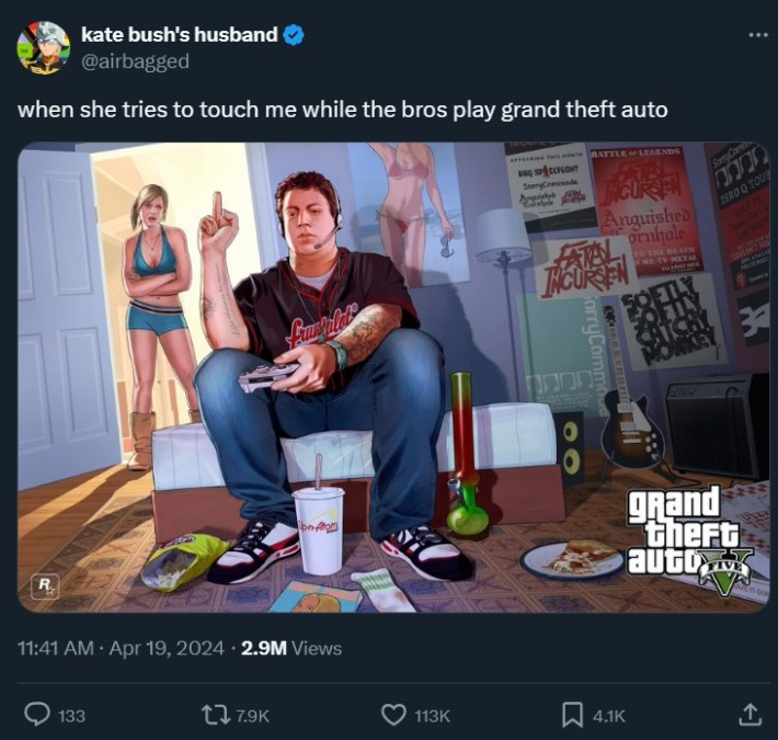 tweet featuring image of man giving wife middle finger as he plays video games with caption "when she tries to touch me while the bros play grand theft auto"