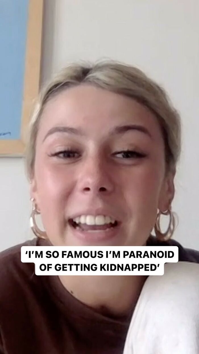 Screenshot of the 'Hawk tuah' girl looking at the camera during an interview. Text overlay reads, "I'm so famous I'm paranoid of getting kidnapped."