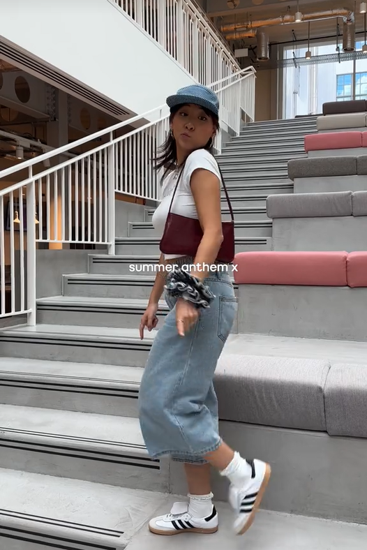 Boots and a slick back bun video with a woman in jeans and a crop top.