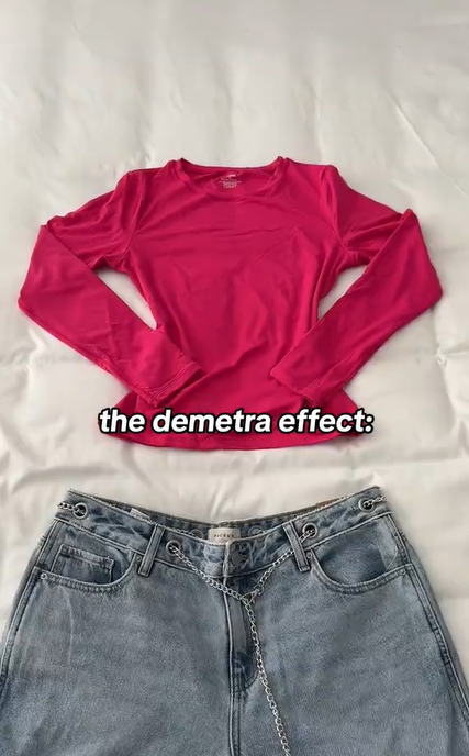 A longsleeve pink t-shirt and baggy jeans laid out neatly on a white comforter. Text overlay reads, "the demetra effect:"