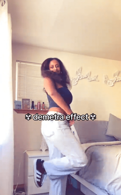 A young woman showing off her outfit with the text overlay, "demetra effect"