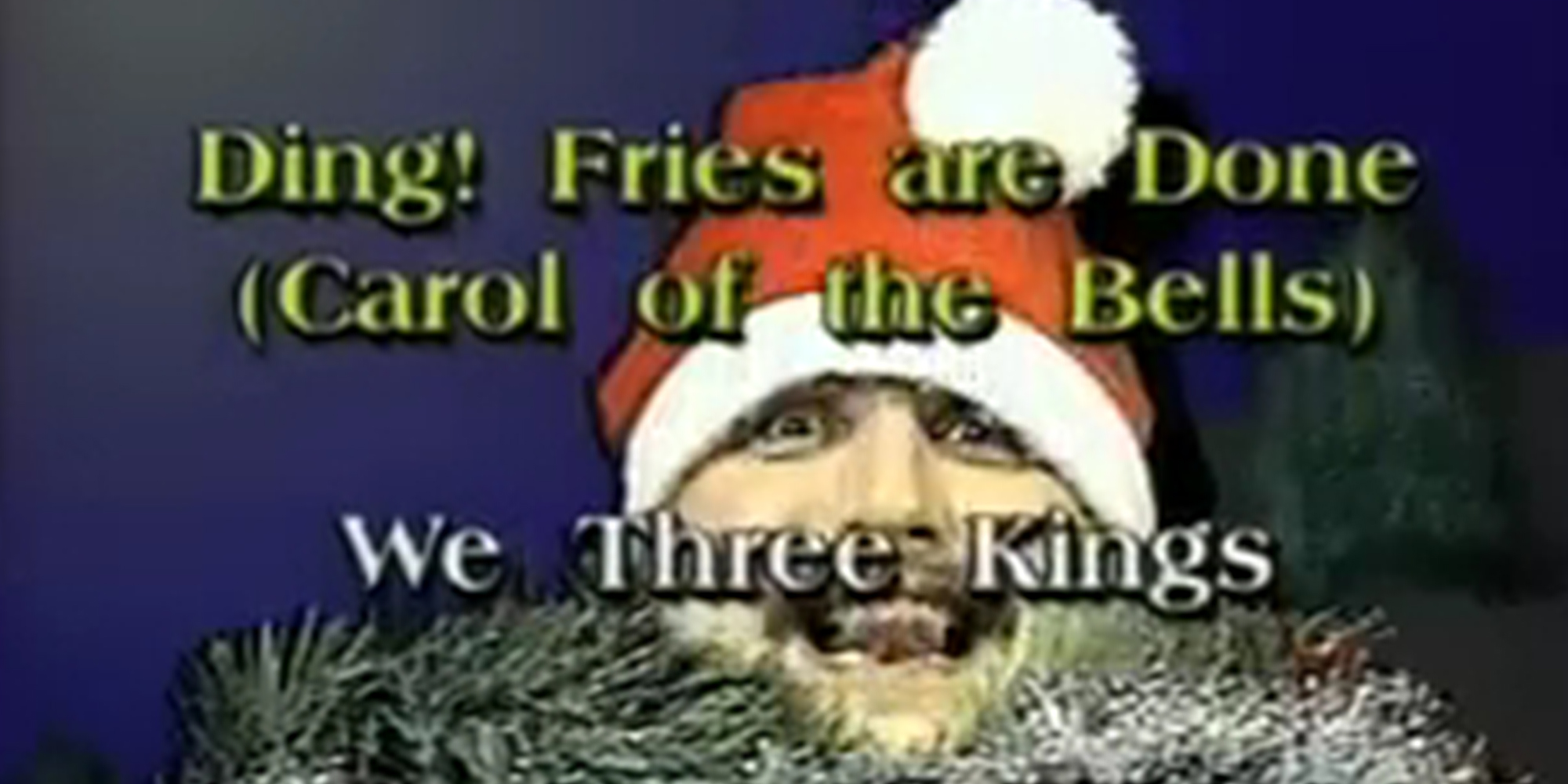 Man wearing Santa hat with "Ding! Fries are Done (Carol of the Bells)" and "We Three Kings" captions