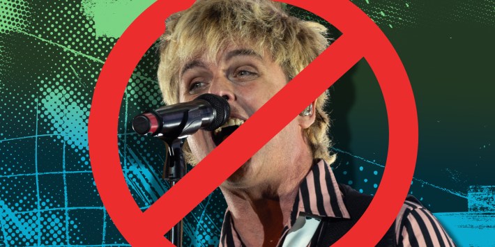 Billy Joe Armstrong of Green Day singing with a red circle with a line through it over him
