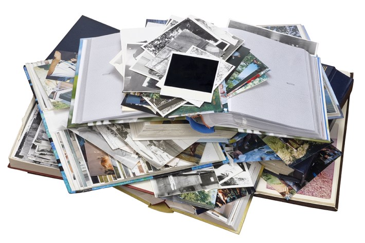 Nostalgia by youth - old family photo albums and photos heap. Isolated with patch