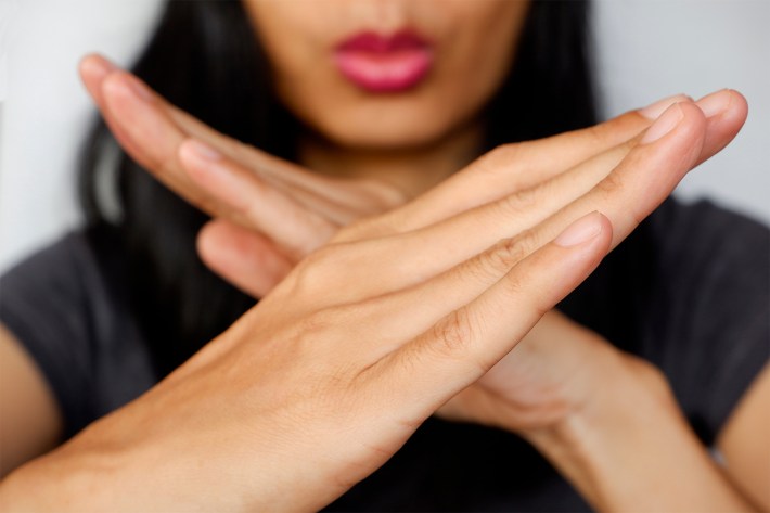 Woman made X sign shape mean to say no