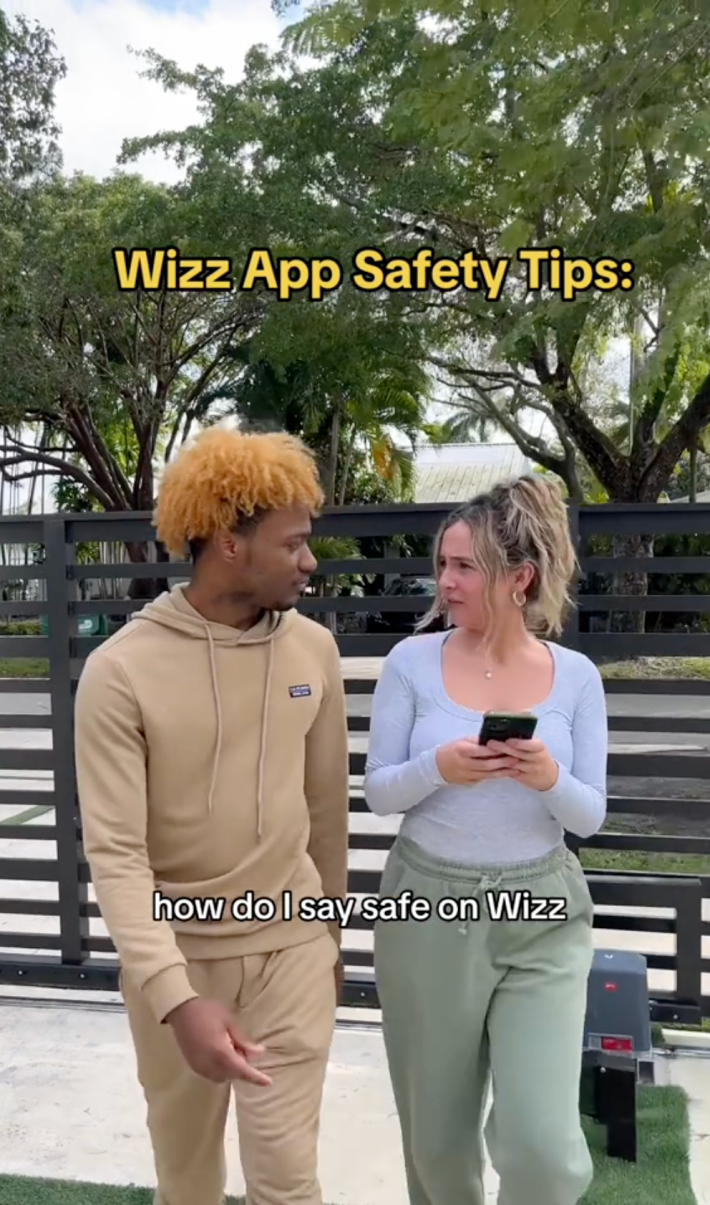Two people talking while walking. Text overlay says, "Wizz App Safety Tips:" and "how do I stay safe on Wizz"