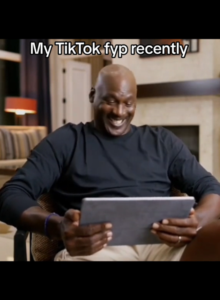 GIFTok video of Michael Jordan giggling at a tablet. Text overlay reads, "My TikTok fyp recently"