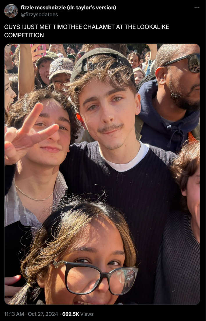 An X post of a user saying "GUYS I JUST MET TIMOTHEE CHALAMET AT THE LOOKALIKE COMPETITION" and a photo of Timothee, a woman in glasses and a man who entered the contest (throwing up a peace sign).