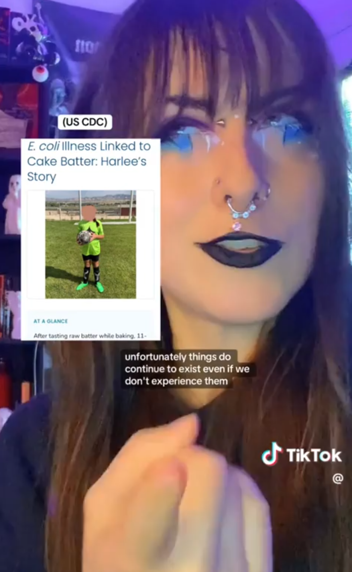 A microbiologist with intense eye makeup warning people against trying the fluffy popcorn TikTok trend. Text overlay reads, "unfortunately things do continue to exist even if we don't experience them."