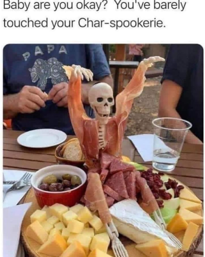 Halloween meme with a photo of a plastic skeleton wrapped around with meats. Text reads, "Baby are you okay? You've barely touched your Char-spookerie."