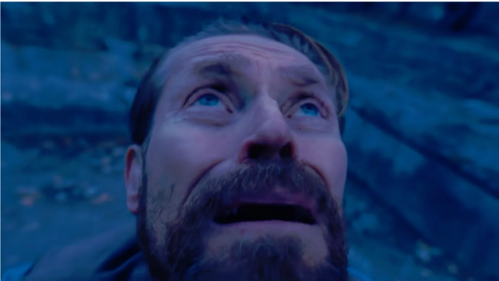 A still of Willem Defoe looking up from the film At Eternity's Gate