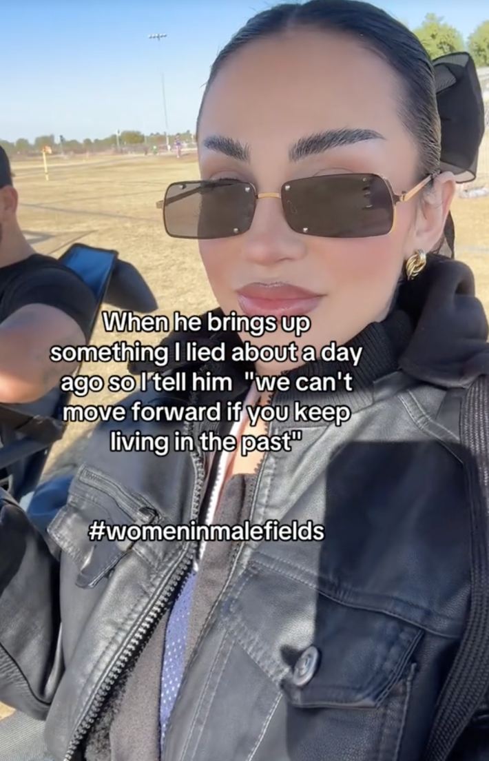 A TikTok video of a woman in her car, smiling, "when he brings up something I lied about...etc. #Womeninmalefields"