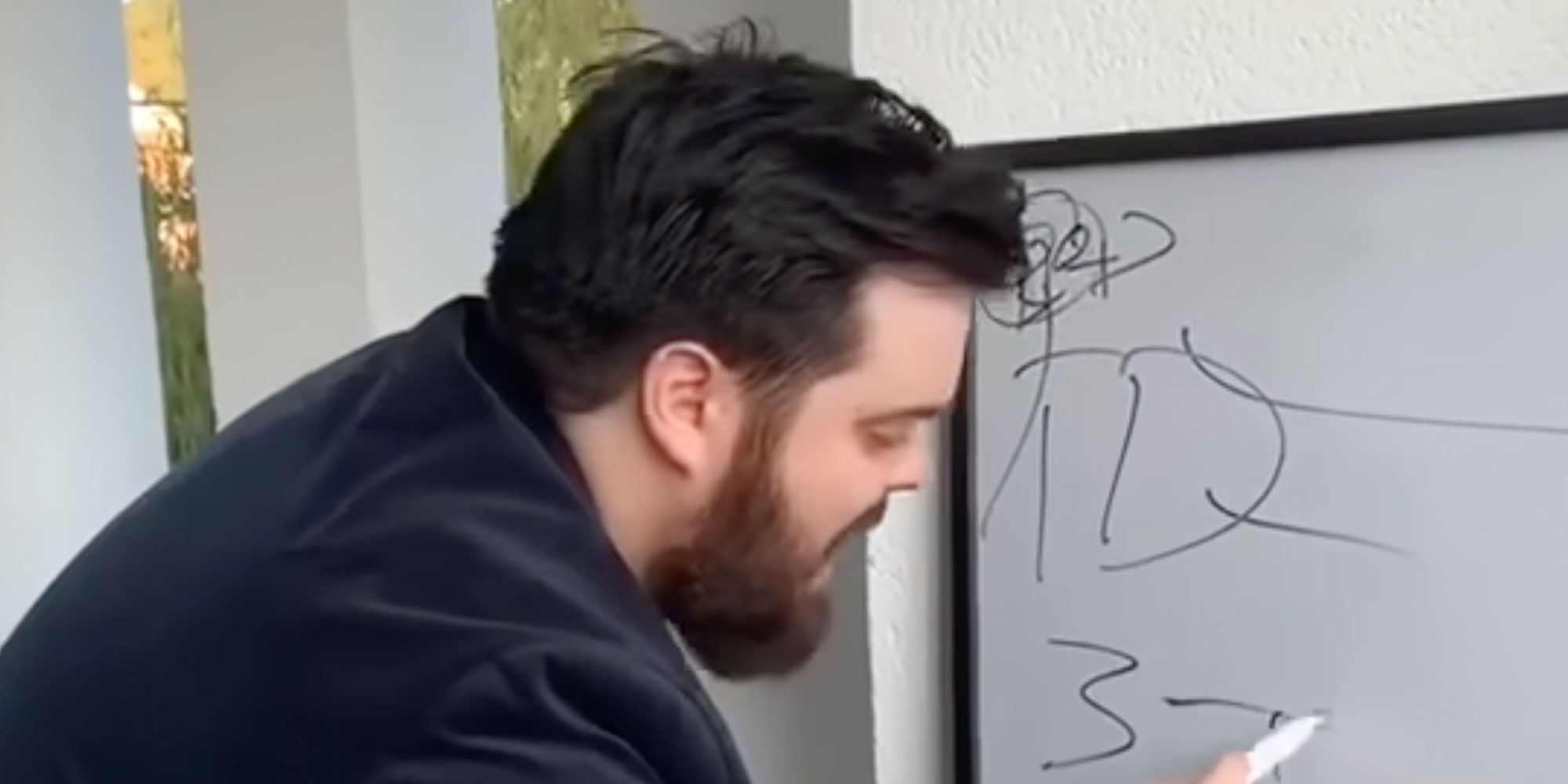 A man writing on whiteboard