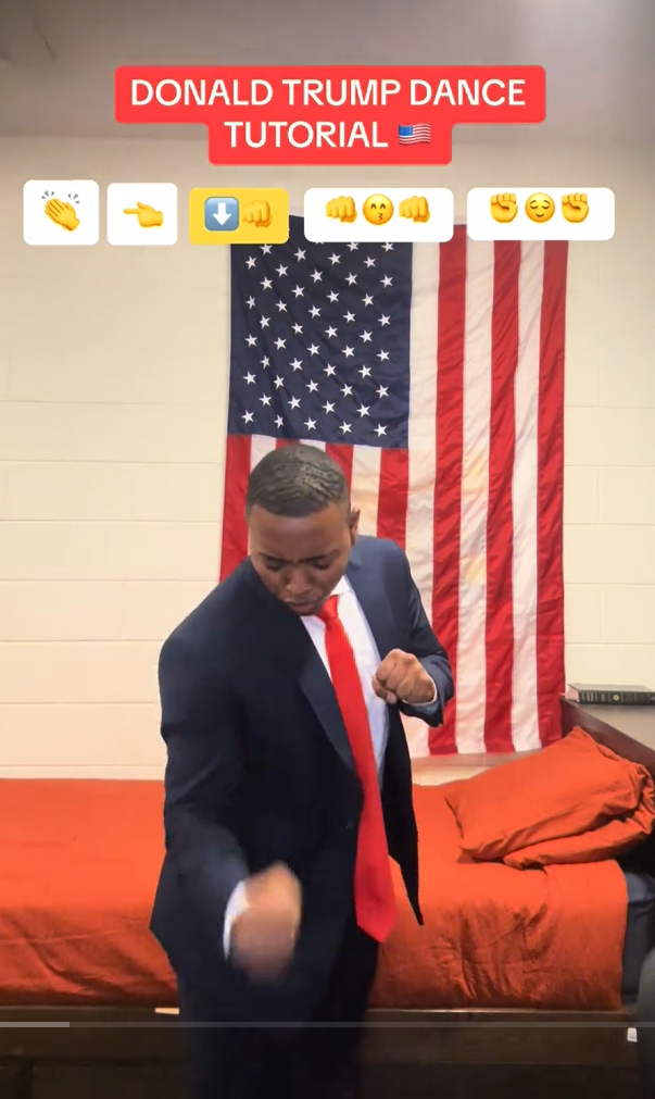 Donald Trump Dance meme tutorial video by a man in a Trump costume in front of a U.S. flag.