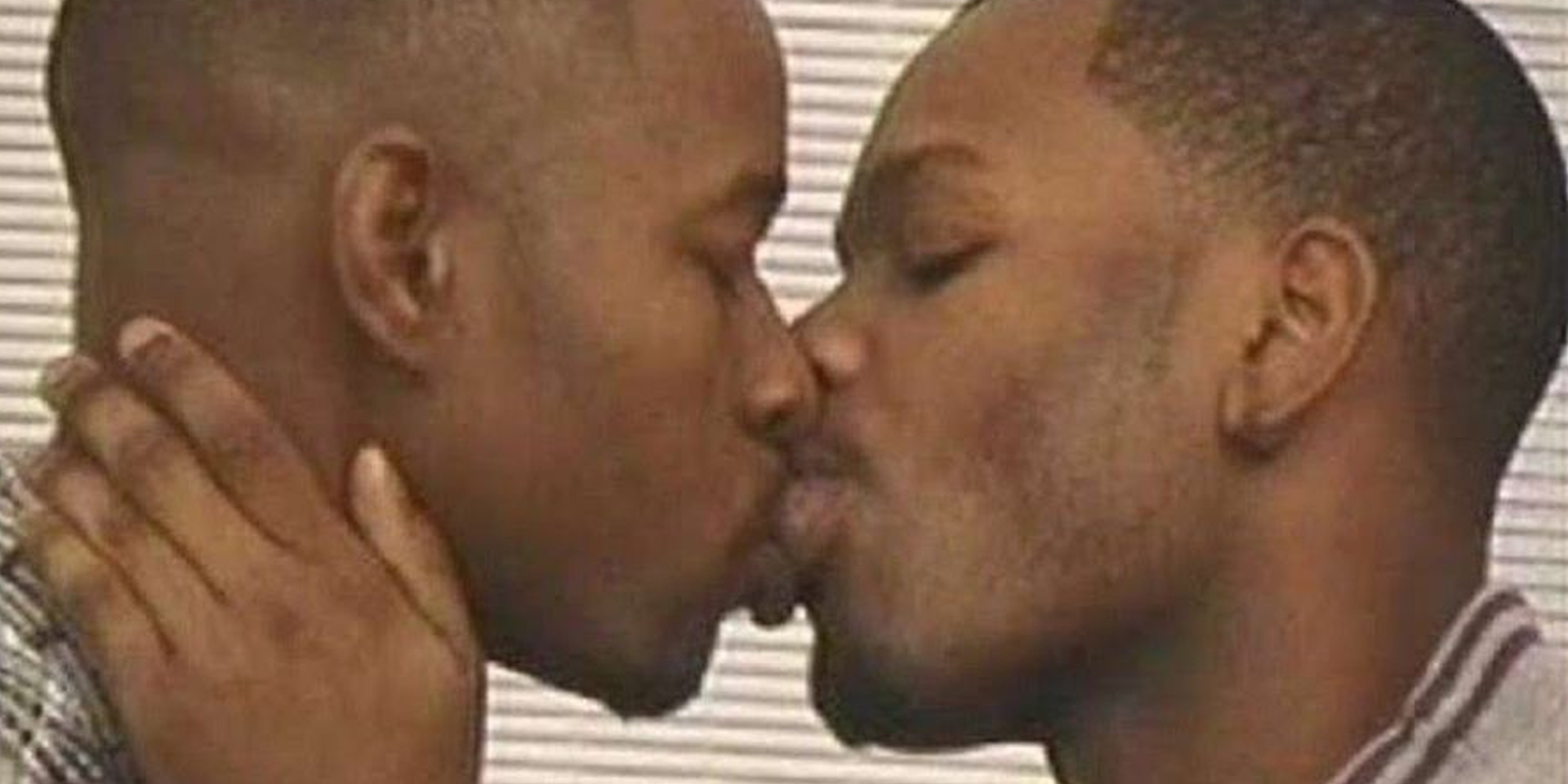 Two men kissing each other
