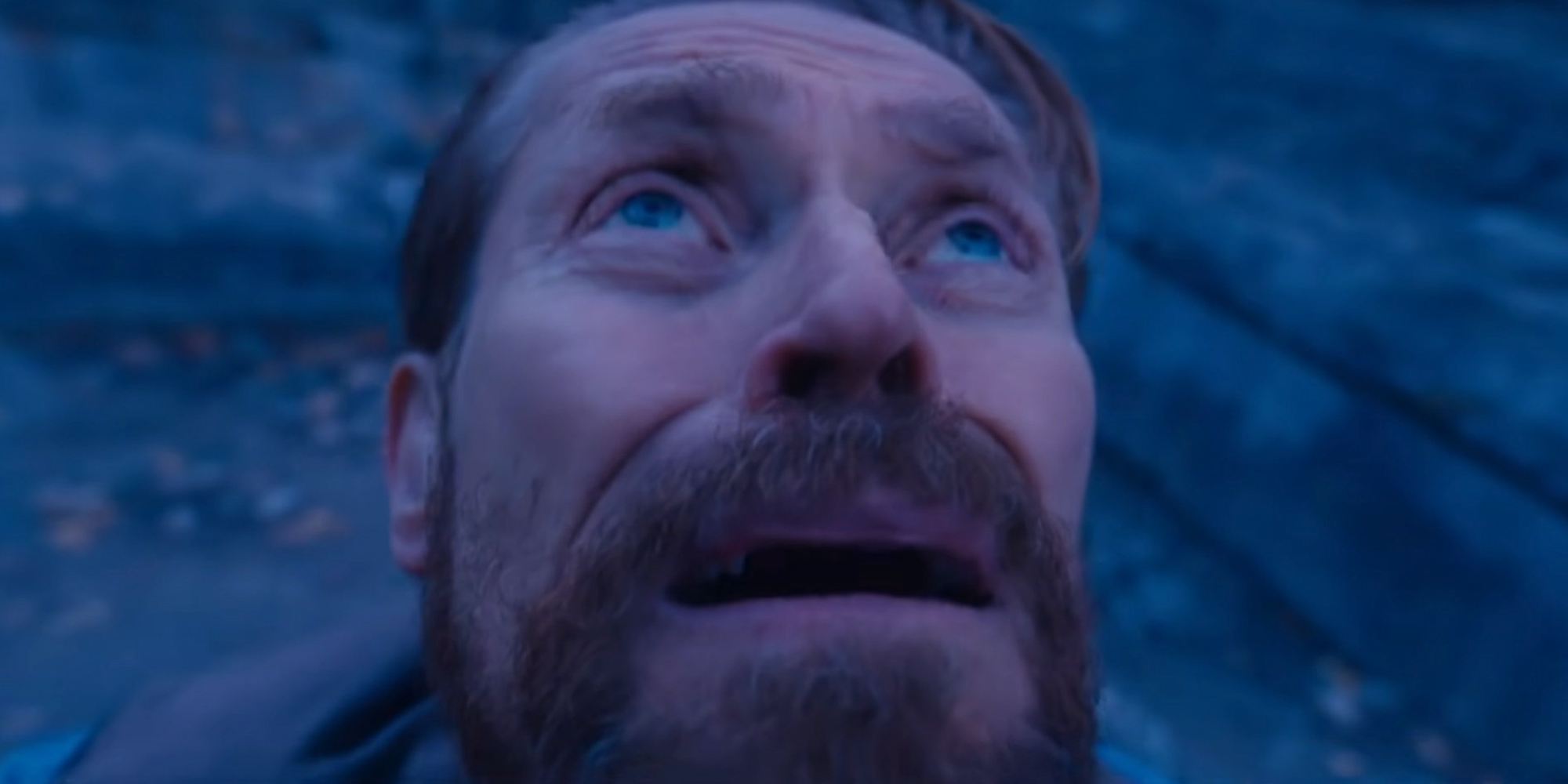 Willem Dafoe looking up at the sky