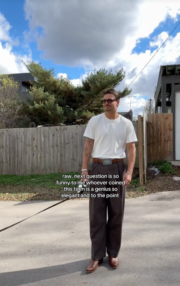 A hot man appreciating the "raw, next question" phrase looking hot while walking his dog