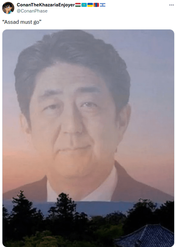 Assad Must Go meme with a transparent image of Shinzo Abe over a sunset.