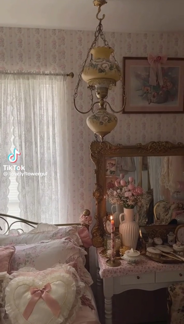 Coquette room with intricate lamps, gilded mirror, and lacy pillows