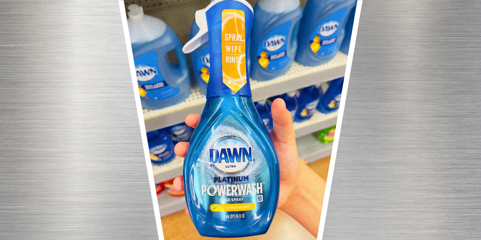 A hand holds a bottle of Dawn Powerwash dish soap in a store aisle.