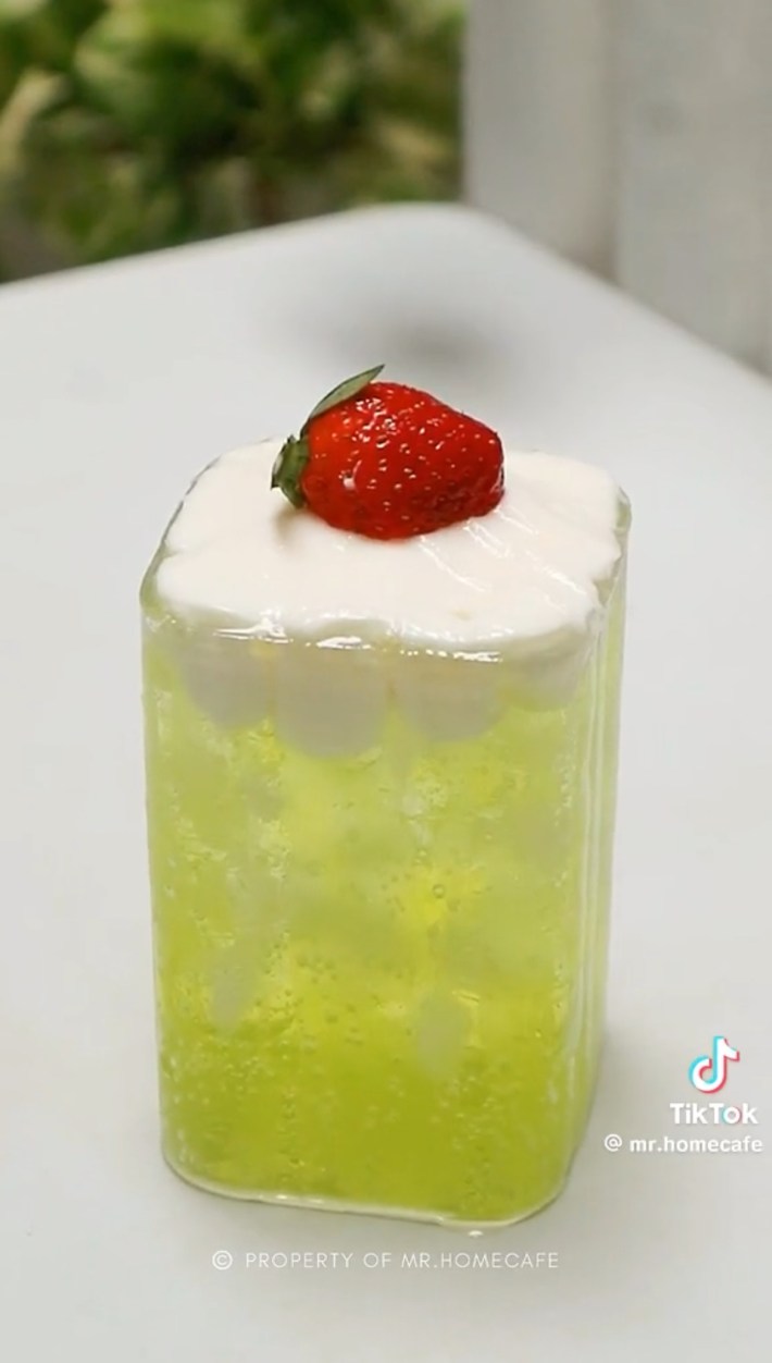 Green soda with strawberry on cream float