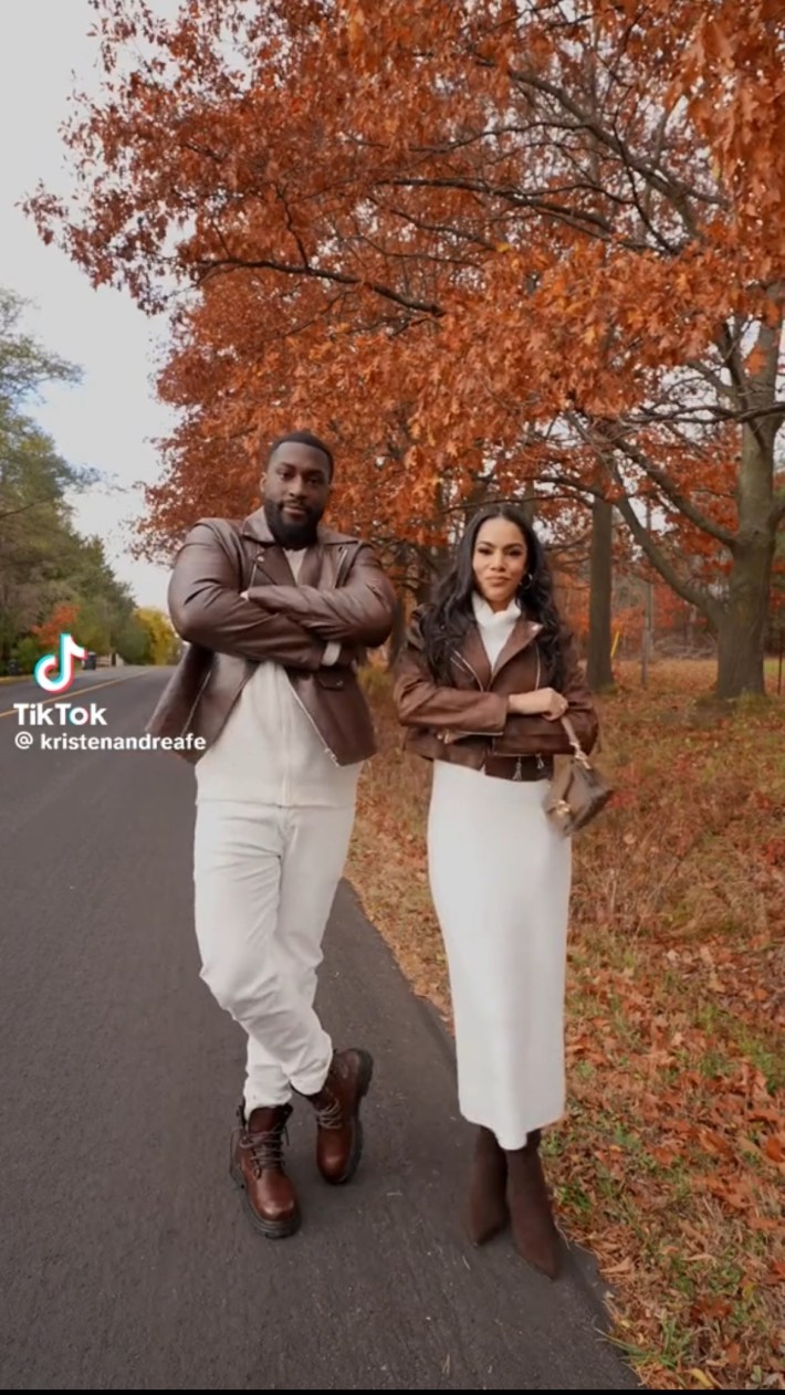 Couple wearing matching white bottoms and brown leather jackets
