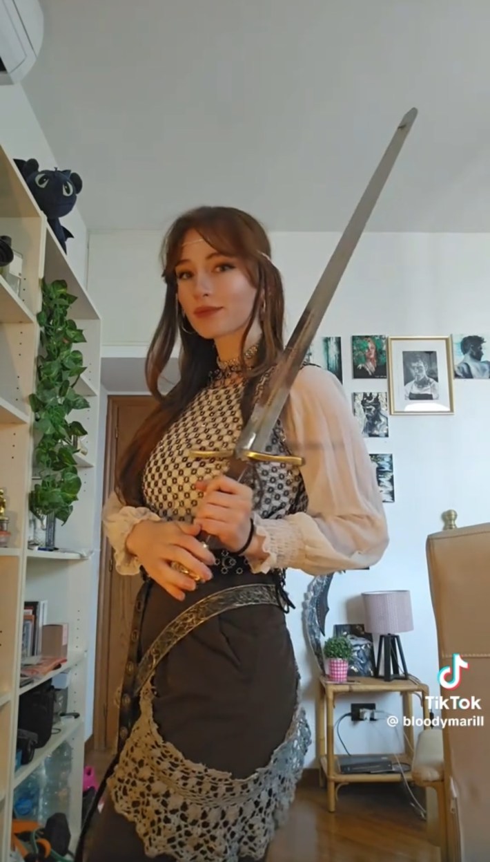 Person in a medieval-inspired outfit carrying sword