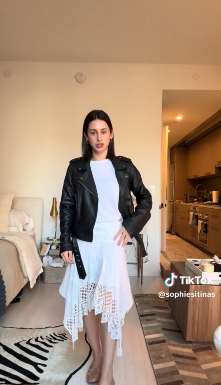 Person in a moto jacket and white skirt