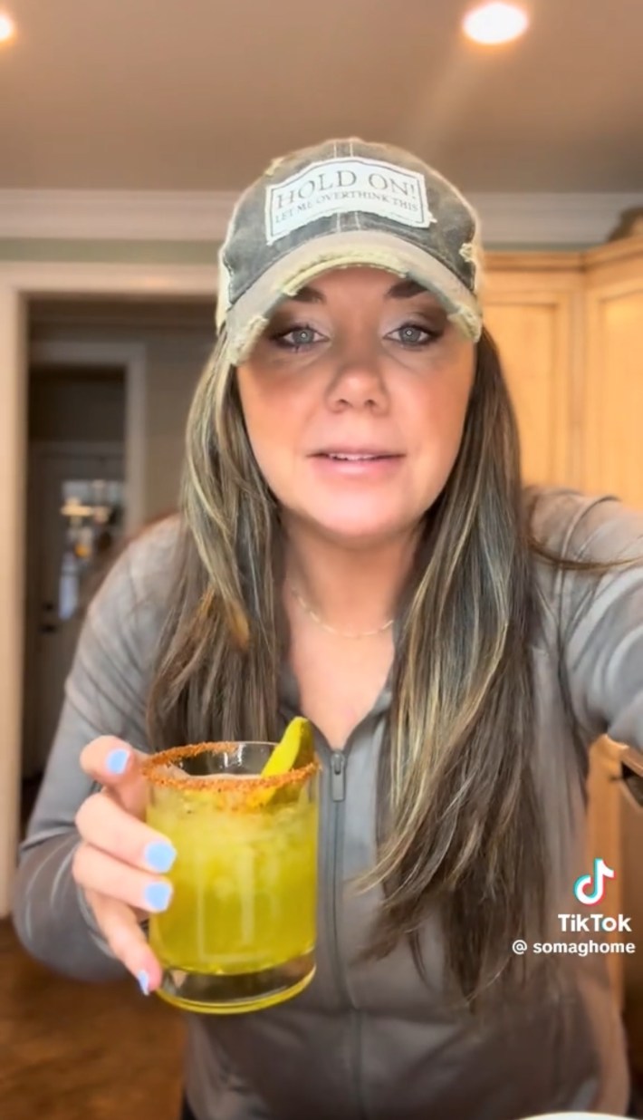 Person holding a pickle margarita