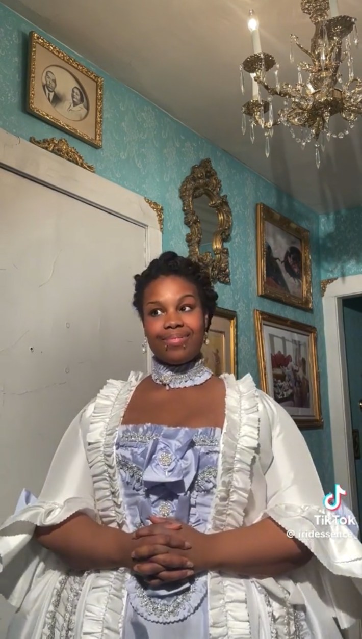 Person in a ruffly white and purple dress